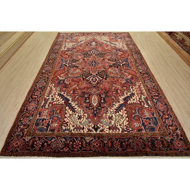An authentic vintage traditional Heriz rug hand-knotted with fine wool and natural dyes. This rug features a central...