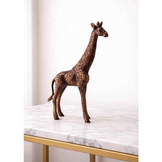 Enhance your home décor with this elegant antique-style giraffe sculpture, beautifully crafted from real metal and...