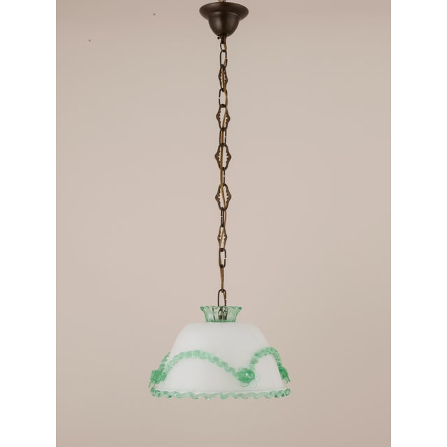 Elegant antique Murano glass pendant light, dating to the 1940s. Featuring opaline white glass with striking arsenic green...