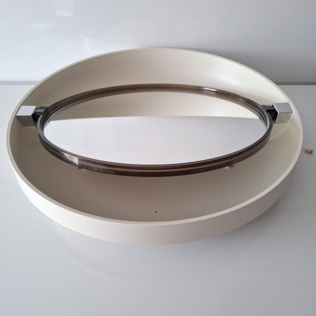 Elegant illuminated wall mirror by allibert, model a 41, manufactured in germany in the 1970s. the mirror is round and...