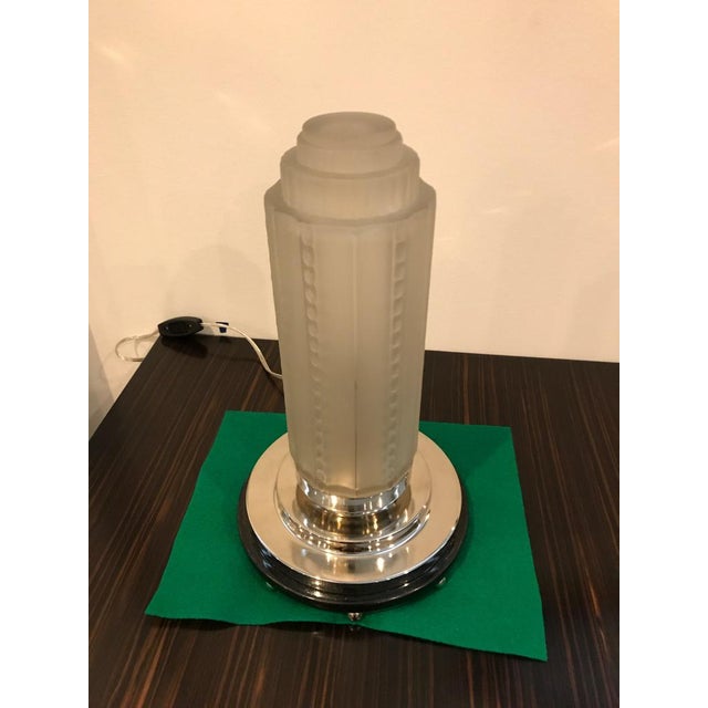 Beautiful pair of French Art Deco table lamps by Genet et Michon. Having clear and frosted shades with intricate geometric...