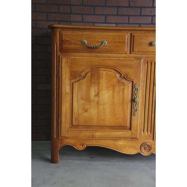 Capturing the grace of a bygone era, this sideboard by Ethan Allen is finely crafted of maple. From the Legacy Collection...
