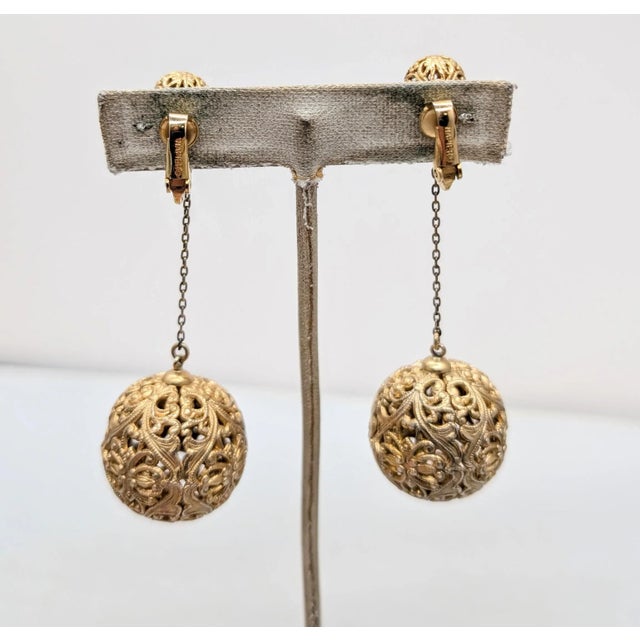1966 goldtone filigree ball drops with small filigree ball drops clip earrings. Marked "NAPIER©" on the clips. Measure: 3...