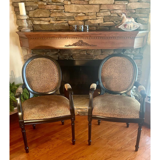 This pair of quality accent chairs are crafted with a beautiful upholstery fabric and the frame in a rich black noir...