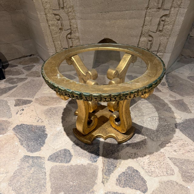 For your consideration, a hollywood regency glass-topped side table features an ornate, gold-leafed base with scrolled...