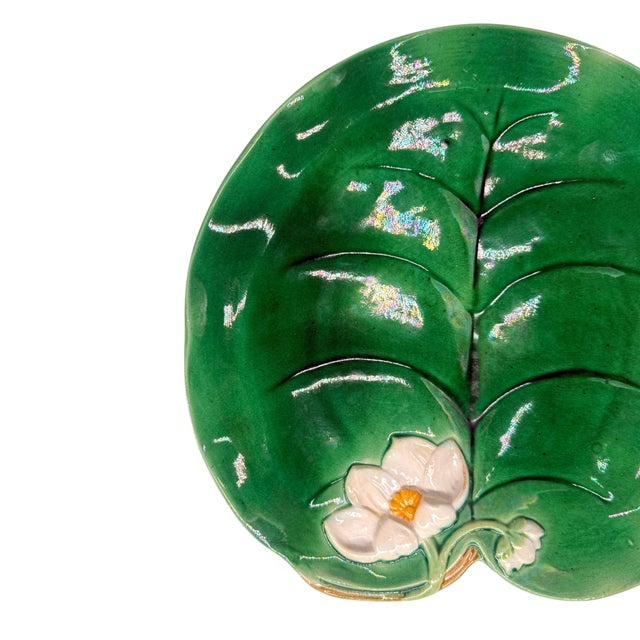 George Jones Majolica Waterlily pad plate glazed in Lush greens, with a relief-molded lily flower; marks to reverse: 'GJ'...