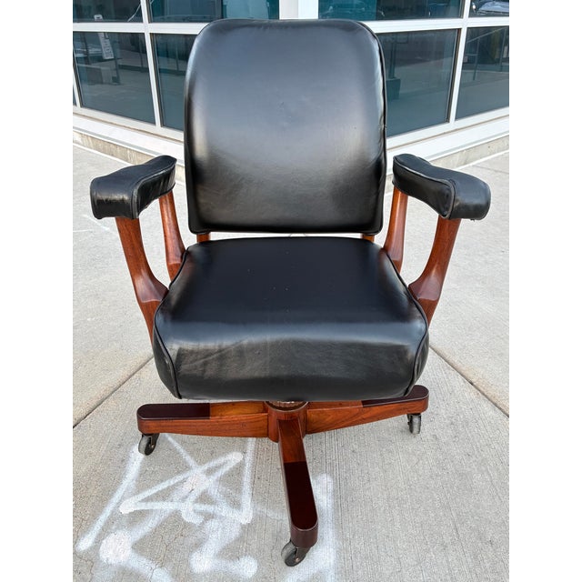 Antique style swivel-tilt executive desk chair in black leather with solid maple frame on four prong base, similar to...