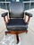 Antique style swivel-tilt executive desk chair in black leather with solid maple frame on four prong base, similar to...