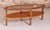 Mid Century oval 2-tier teak coffee table with a smoked glass top and brass feet by G-plan, circa 1970s. The table has...