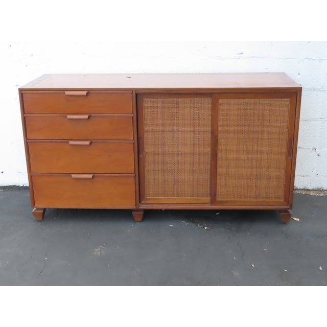 This magnificent Sideboard is made of wood, solid wood, cherry, walnut, veneer, and caning. This Sideboard was made by...