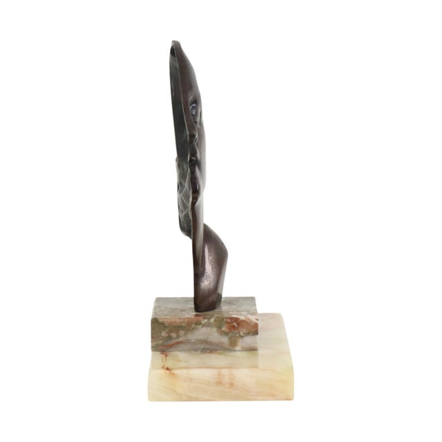 A beautiful Art Deco bronze sculpture of a young woman in profile, executed in the characteristic Art Deco style and...