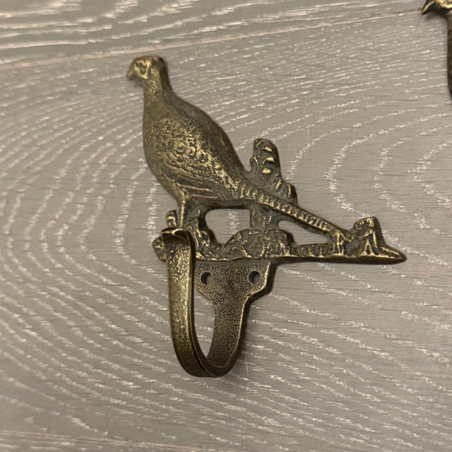 A handsome, decorator-grade complete set of five (5) vintage-style solid brass architectural wall hooks. Featuring a...