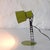 Desk lamp in yellowish-green lacquered metal, with a chromed metal shaft featuring circular perforations of decreasing...