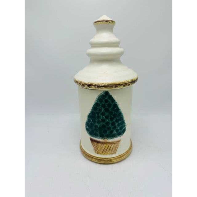 Pretty canister with a topiary design. Useful and elegant