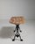 A classic French bistro table dating to the early 20th century, featuring a substantial cast iron base paired with a...