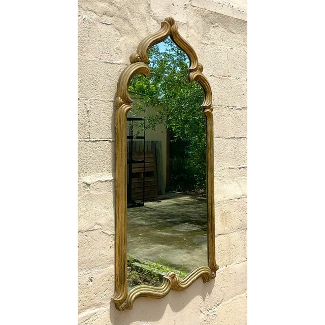 A fabulous vintage Boho wall mirror. A chic Moroccan style frame with a gilt finish. Monumental in size and drama....