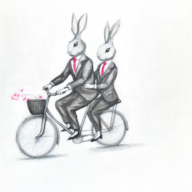 A framed print of two bunnies wearing suits riding a bike by Max and Alma. Max & Alma create kitsch, pop, feel-good art...