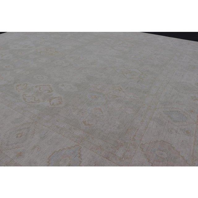 Measures: 13'2 x 14'10 Modern Oushak Rug with Warm Field and Light Blue and Green Accents. Keivan Woven Arts /...