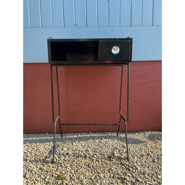 Metal telephone stand painted black (appears to be original paint) with accompanying bench Steel rod accented frame and...
