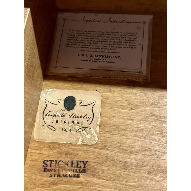 A classic three-drawer chest by Stickley, crafted in solid cherry with traditional American styling. The piece features...