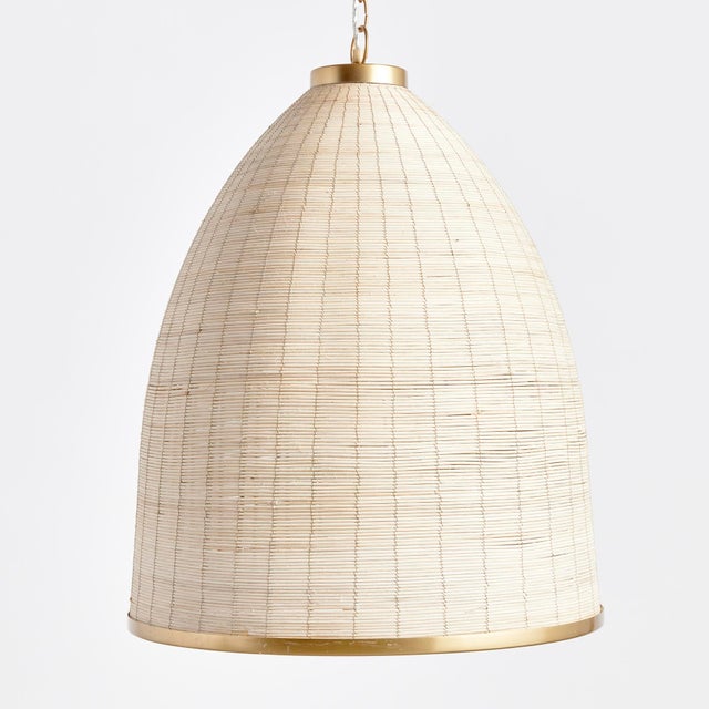 Woven in a natural cane rattan, with subtle variations in color making each one truly unique, this pendant is an instant...