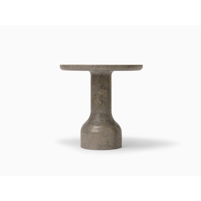 Designed by the Danish duo Depping & Jørgensen, this side table is a refined piece of art carved from solid limestone,...