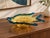 A striking vintage art glass bowl designed in the form of a stylized fish. The piece features a luminous amber-gold body...