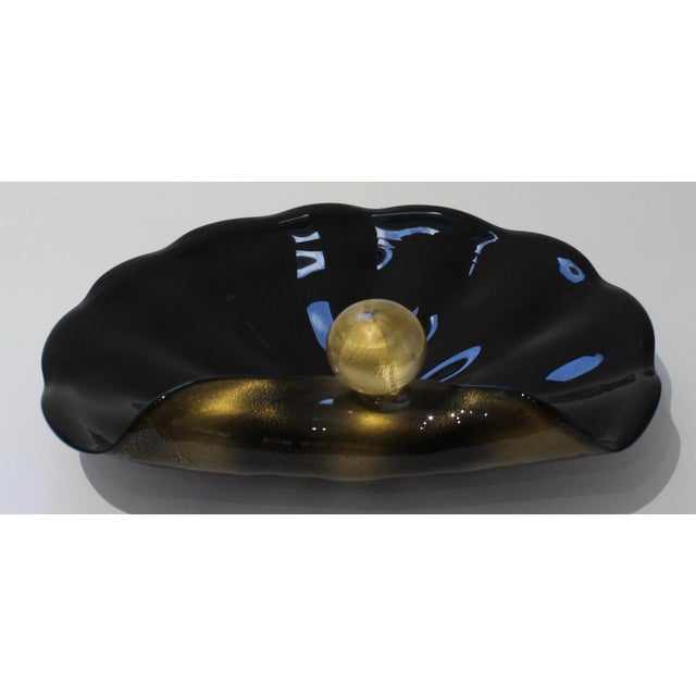 Remarkable vintage shell dish, with Zanetti's iconic black glass with wine-red interior highlights, the entire back is...