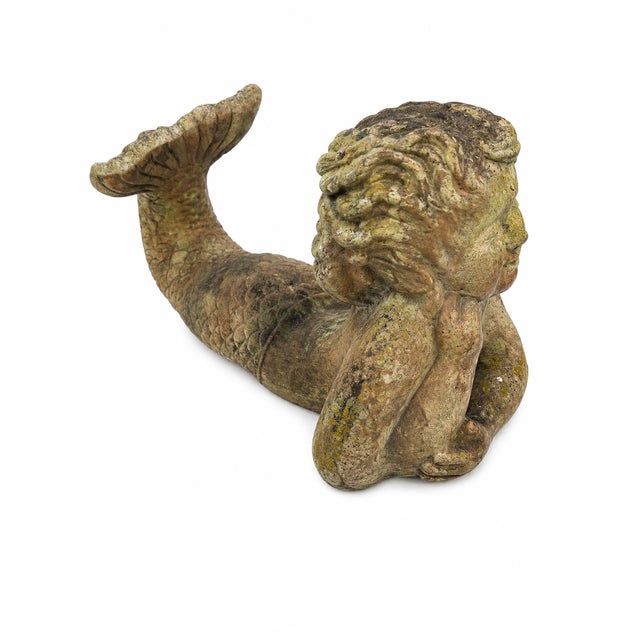 Striking vintage terracotta sculpture depicting a whimsical mermaid in a relaxed, contemplative pose. The piece features...