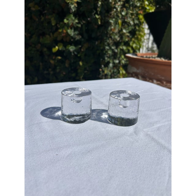 Danish clear glass candleholders with cylindrical form and flat base. Each holder features a centered 1/2" candlestick...