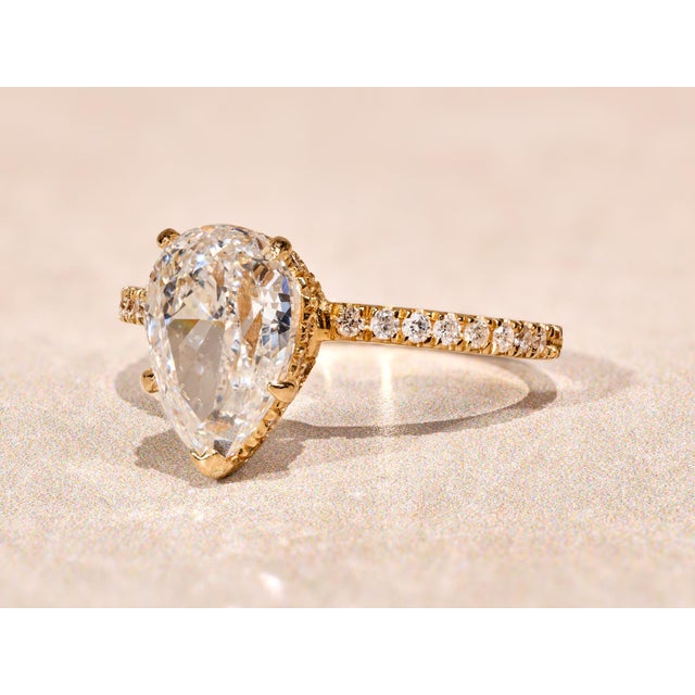 The West River: 2.12 Carat Pear Shaped Diamond Engagement Ring. The ring features a central 2.12 carat pear brilliant cut...