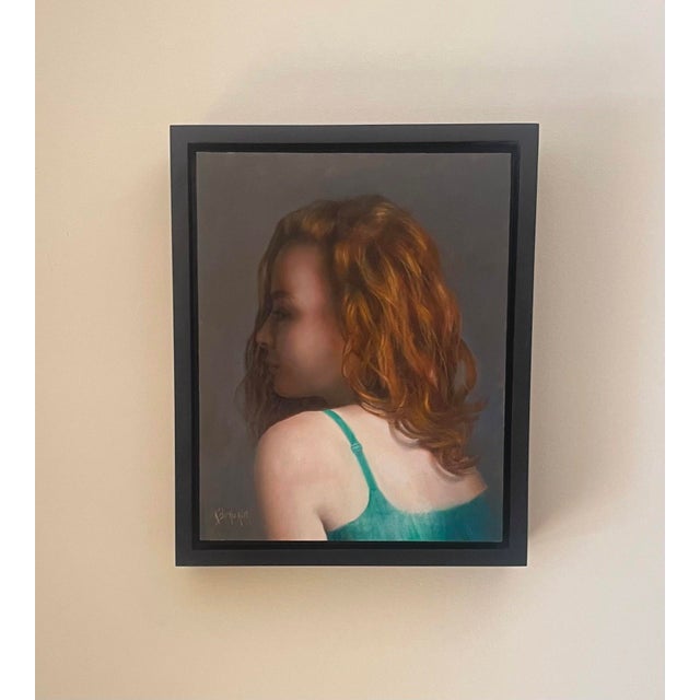 This oil on panel painting captures a figure in profile, draped in a delicate green garment that contrasts with the rich...