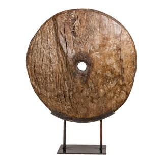 Ancient Cart Wheel Mounted on Black Lacquer Base with Rustic Character For Sale