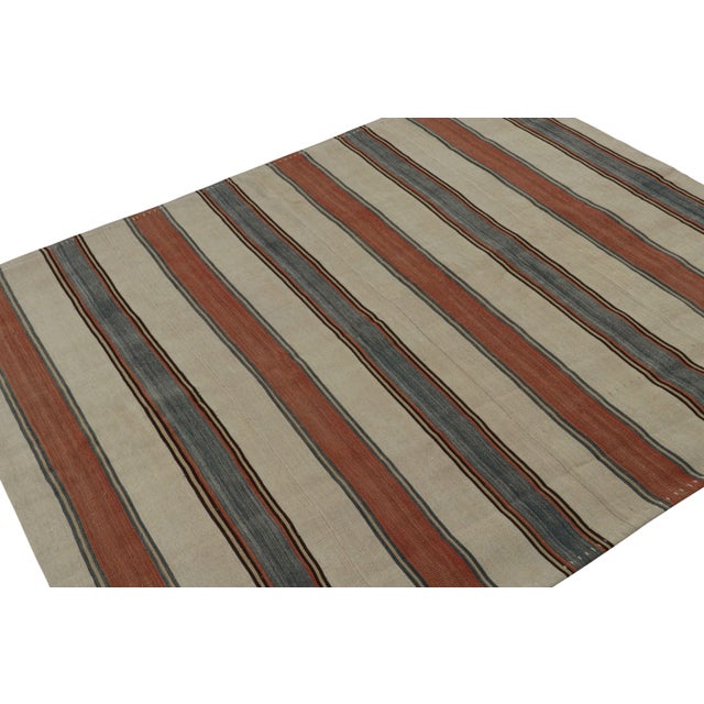 Handwoven in wool, circa 1950-1960, this 5x6 vintage Afghan tribal kilim rug, with stripes in red, beige/brown and blue,...