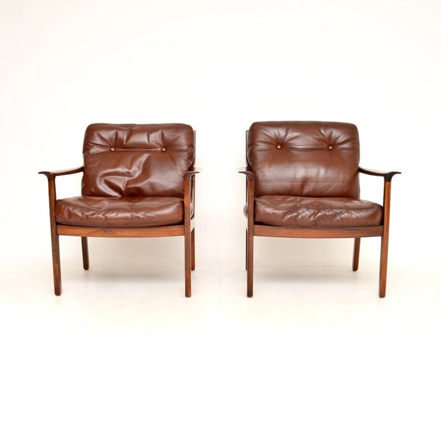 A beautifully designed pair of vintage Scandinavian leather armchairs by Frederik Kayser. They were made in Norway by...