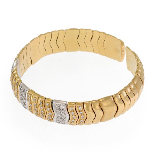 This lovely Estate bracelet is crafted from 18k yellow and white gold featuring a 12mm wide flex band in a dome shape with...