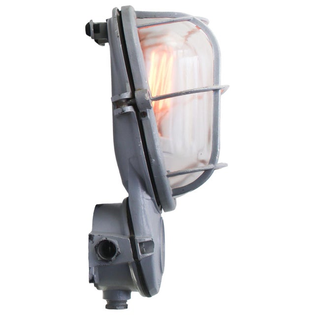 industrial wall lamp made by Industria Rotterdam cast aluminum with clear glass E27/E26 This piece has an attribution...