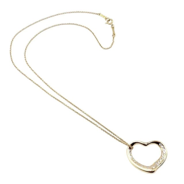 About This Piece: The Tiffany & Co Elsa Peretti necklace is crafted from 18k yellow gold and features an open heart...