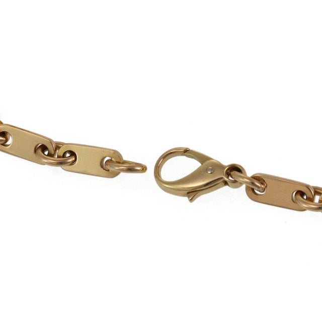 This is an authentic vintage bracelet by Cartier. It is crafted from 18k yellow gold featuring slim long flat links which...