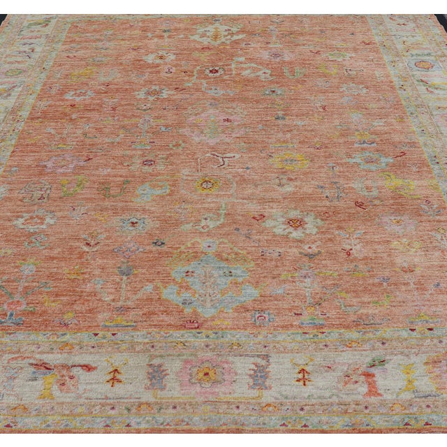 Vibrant Floral Medley on Salmon Pink Hand-Knotted Rug by Keivan Woven Arts. rug / AN-149682, Turkish 21st Century....