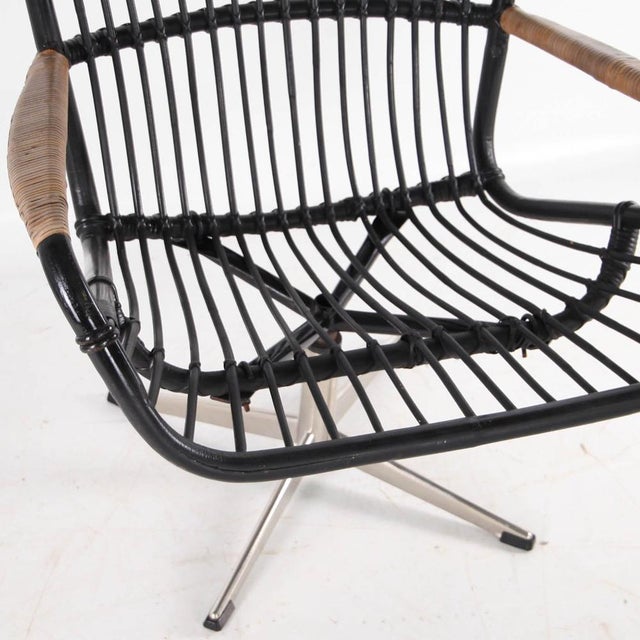 Stunning blackened rattan armchair with chrome legs. Exquisite with its rare combination of these two materials, it...