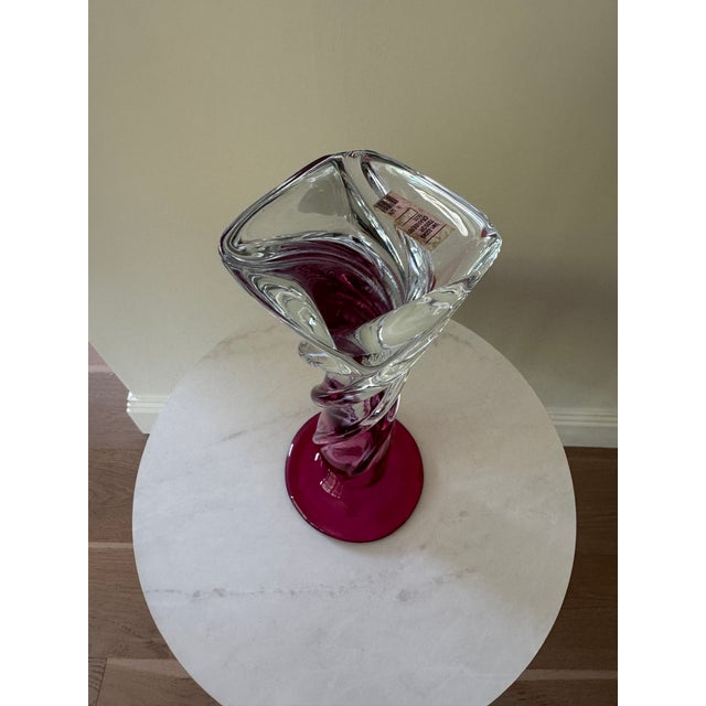A stunning example of American hand – blown art glass featuring a bold cranberry, ruby trumpet flare a top a sculptural...