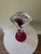 A stunning example of American hand – blown art glass featuring a bold cranberry, ruby trumpet flare a top a sculptural...