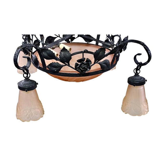 This is a very good example of a forged iron and art glass chandelier that is attributed to Mueller Freres. The high...