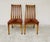 This elegant pair of chairs boasts a timeless design, combining comfort and sturdiness. Made of solid wood with a honey...