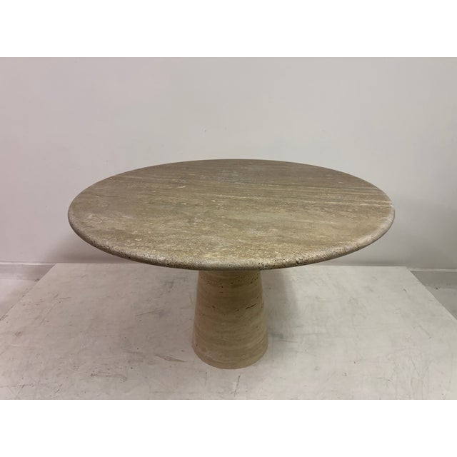 This elegant round dining or centre table is crafted entirely from solid Italian travertine, showcasing the timeless...