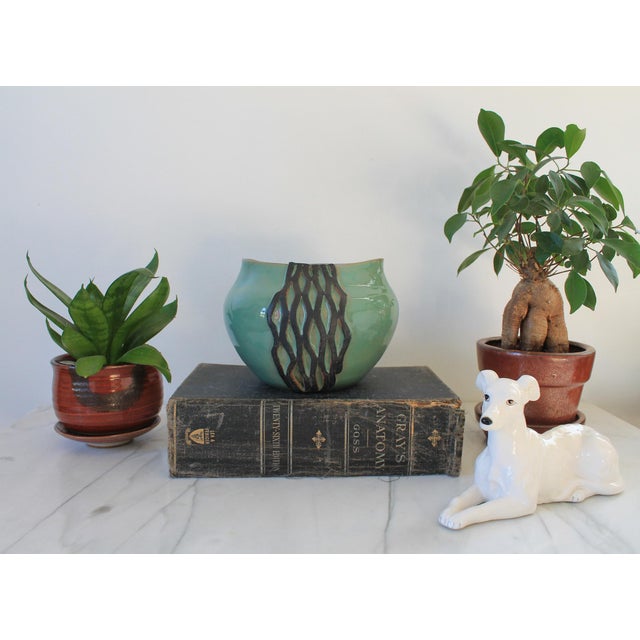 Vintage handmade turquoise studio pottery vase with a dark geometric carved pattern. Lightly signed by artist on bottom....