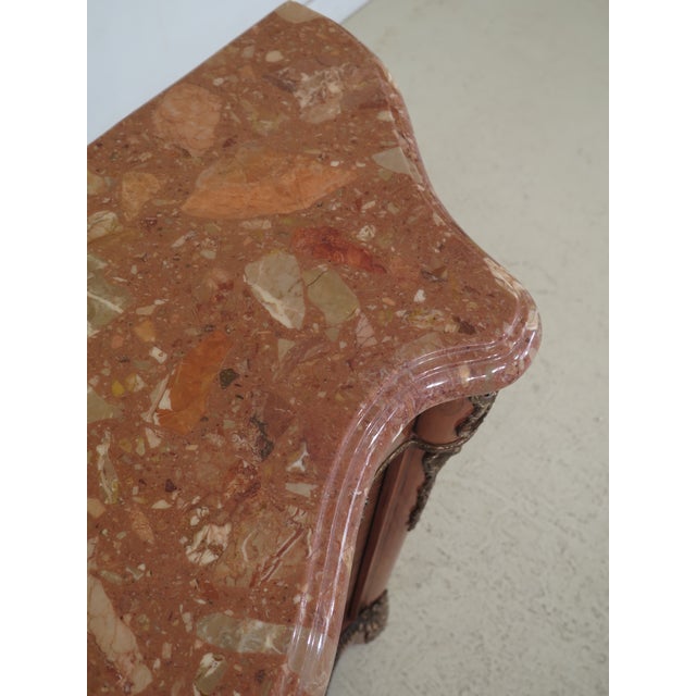 Italian marble top inlaid commode with bronze trim. Italian made. Features high quality construction, nice inlay work...