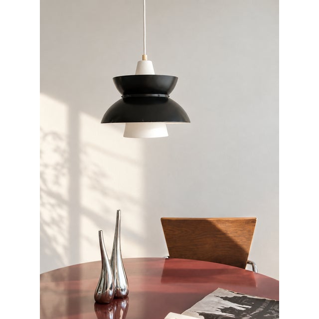 Few Danish lamps carry a story quite like this one. The Doo-Wop — also known as the Søværnspendel, or "Navy pendant" — was...