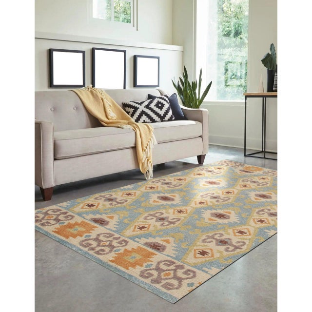 Freya Traditional Blue Hand Knotted Wool Rug, Country of Origin: India. This exceptional piece showcases the enduring...